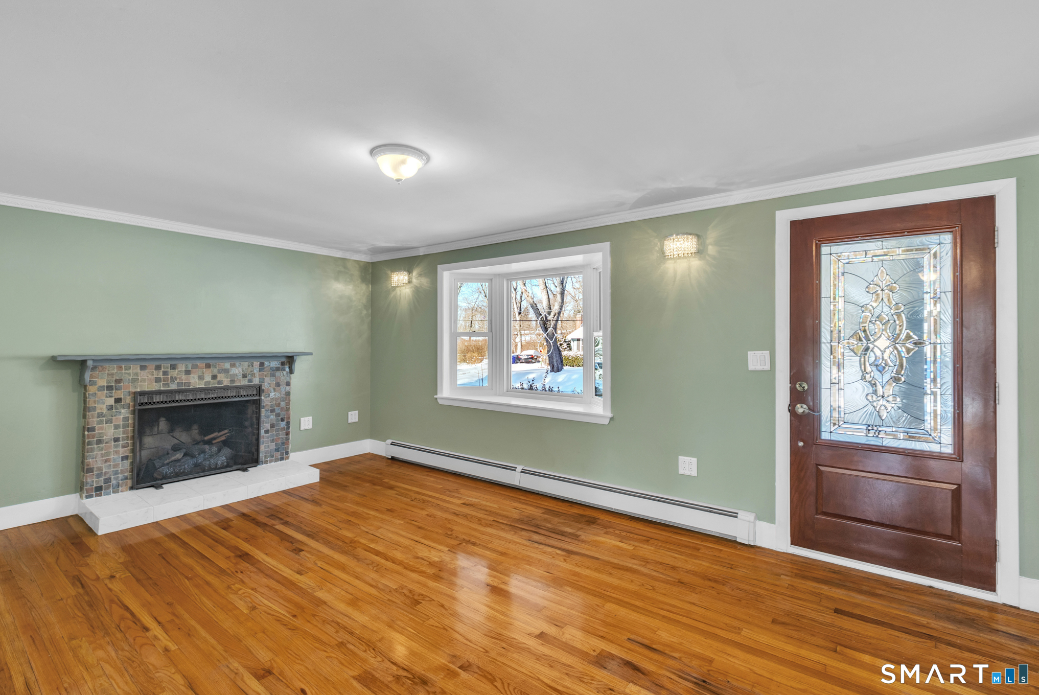 9 Carney Road Enfield, CT 06082 - Photo 12 of 40 an empty room with windows and fireplace