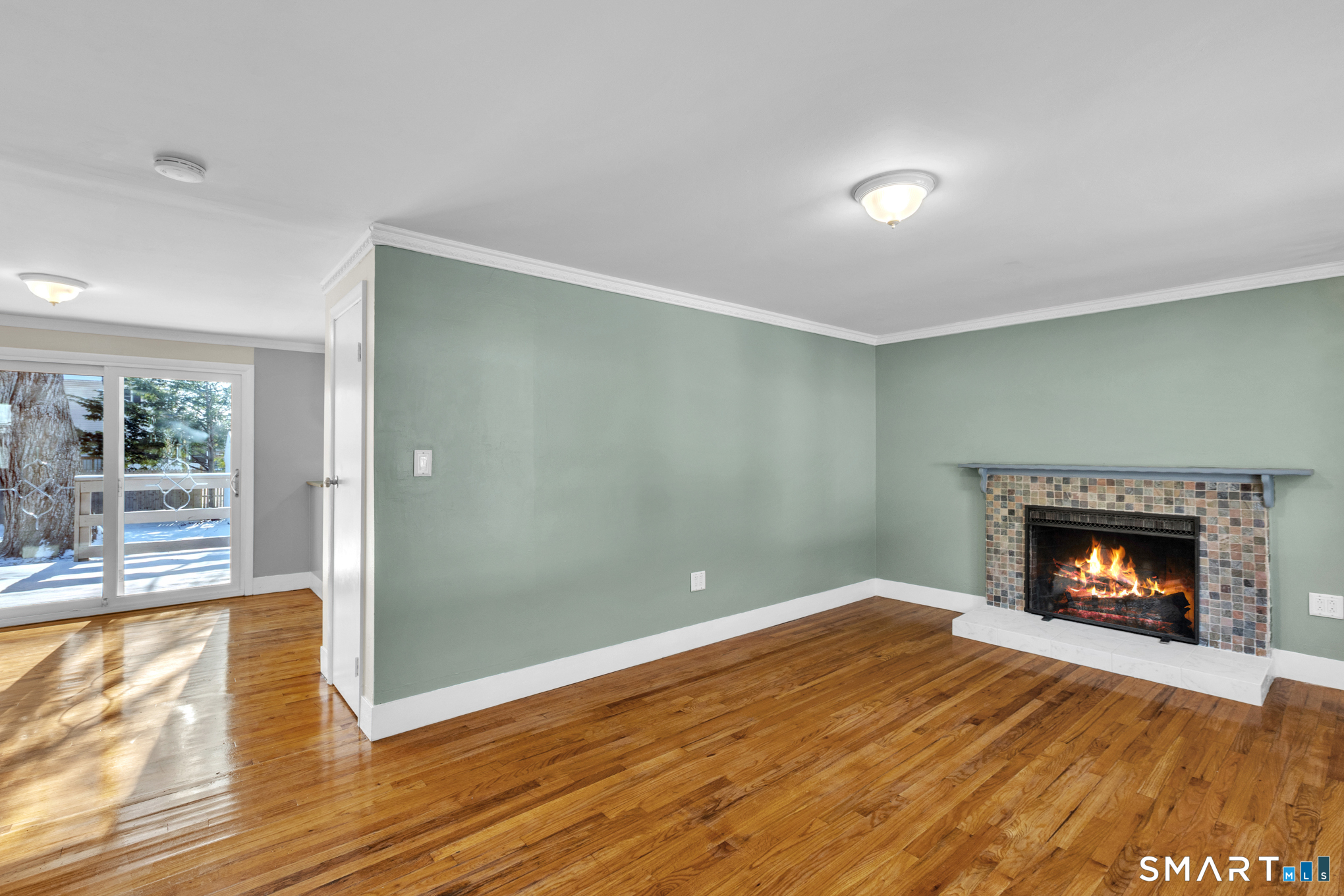 9 Carney Road Enfield, CT 06082 - Photo 15 of 40 a view of an empty room with wooden floor fireplace and a window