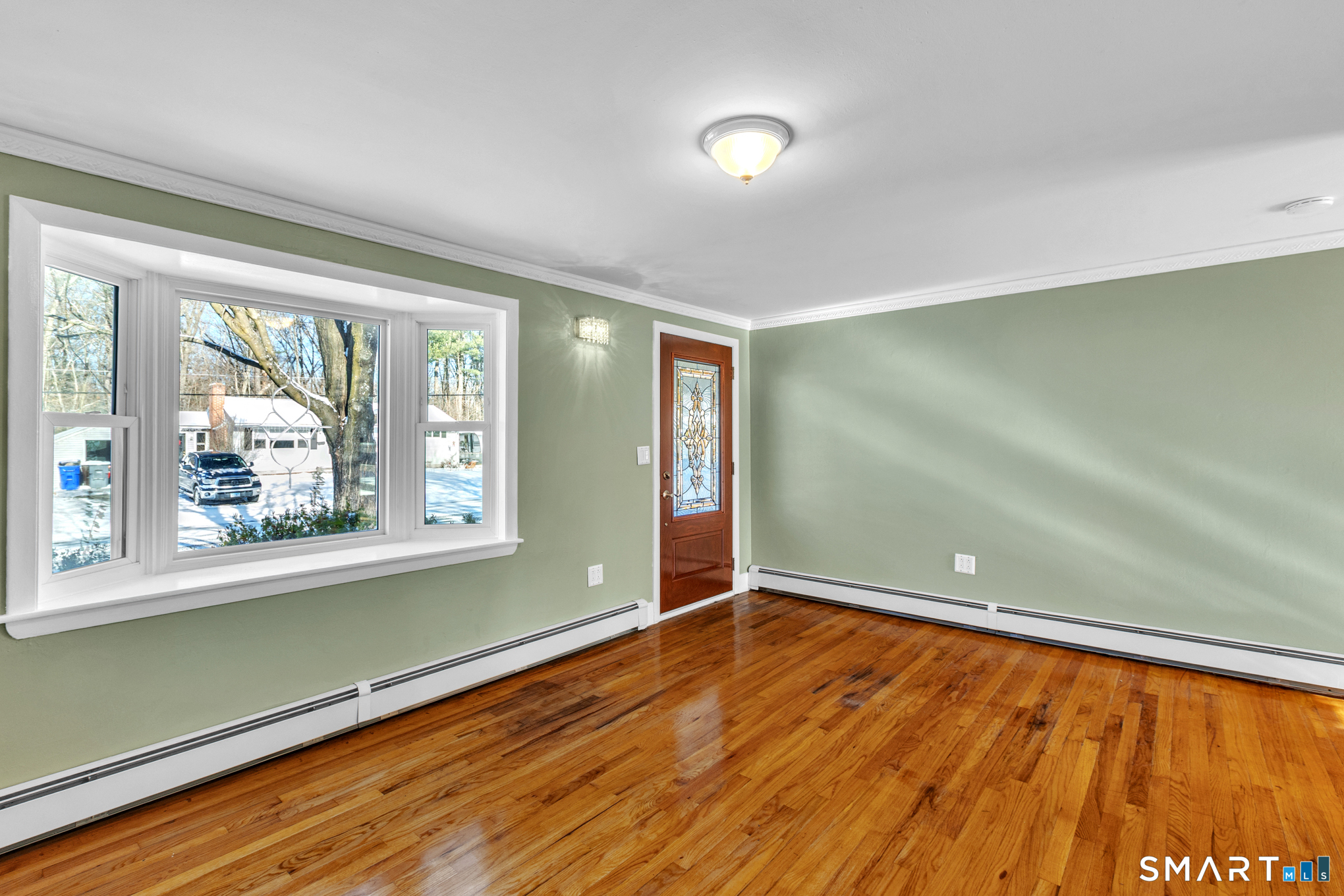 9 Carney Road Enfield, CT 06082 - Photo 17 of 40 an empty room with wooden floor and a window