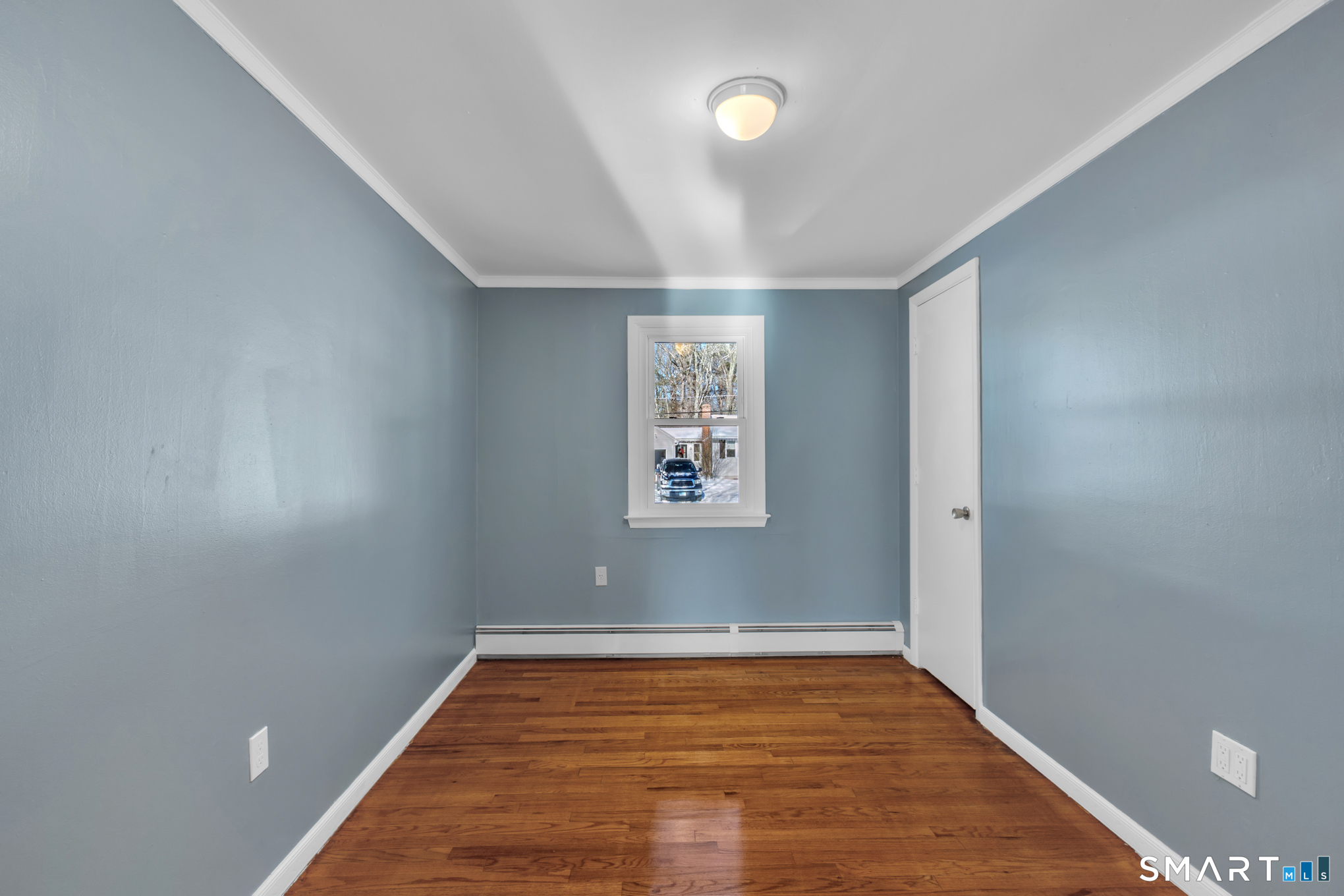 9 Carney Road Enfield, CT 06082 - Photo 18 of 40 an empty room with wooden floor and windows