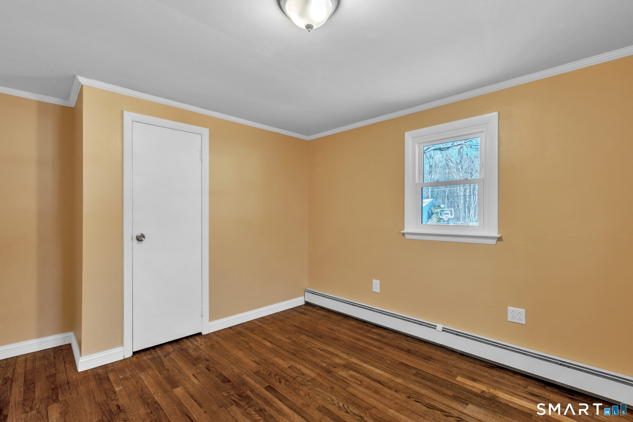 9 Carney Road Enfield, CT 06082 - Photo 25 of 40 a view of an empty room with wooden floor and a window