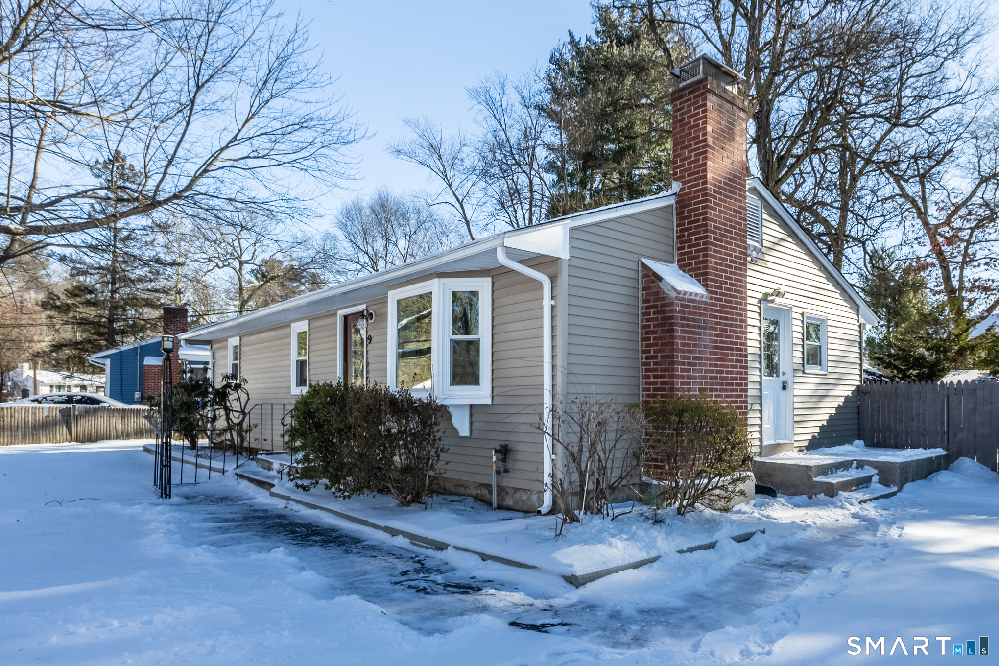 9 Carney Road Enfield, CT 06082 - Photo 3 of 40 a front view of house with yard and trees around