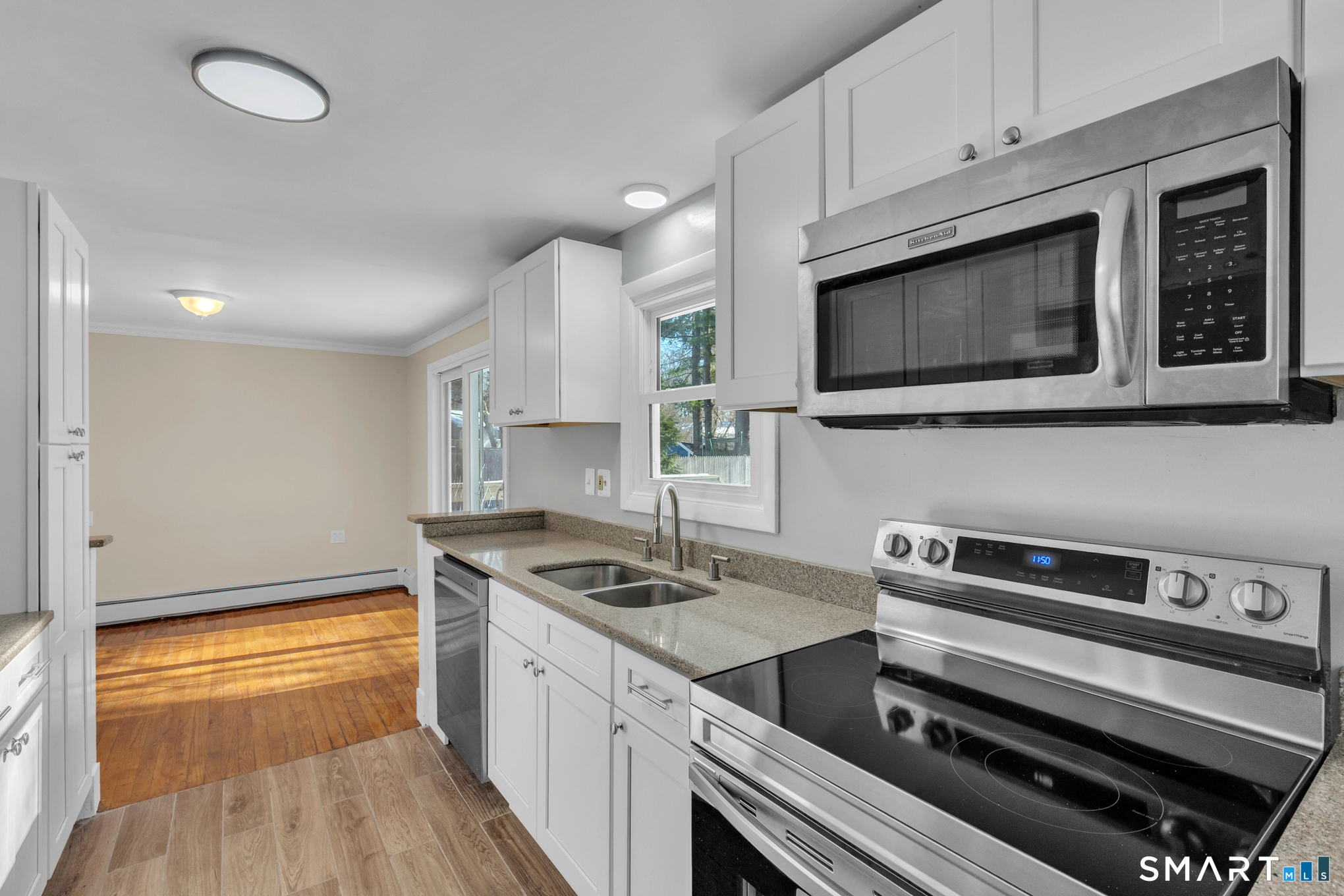9 Carney Road Enfield, CT 06082 - Photo 4 of 40 a kitchen with stainless steel appliances a stove microwave and sink