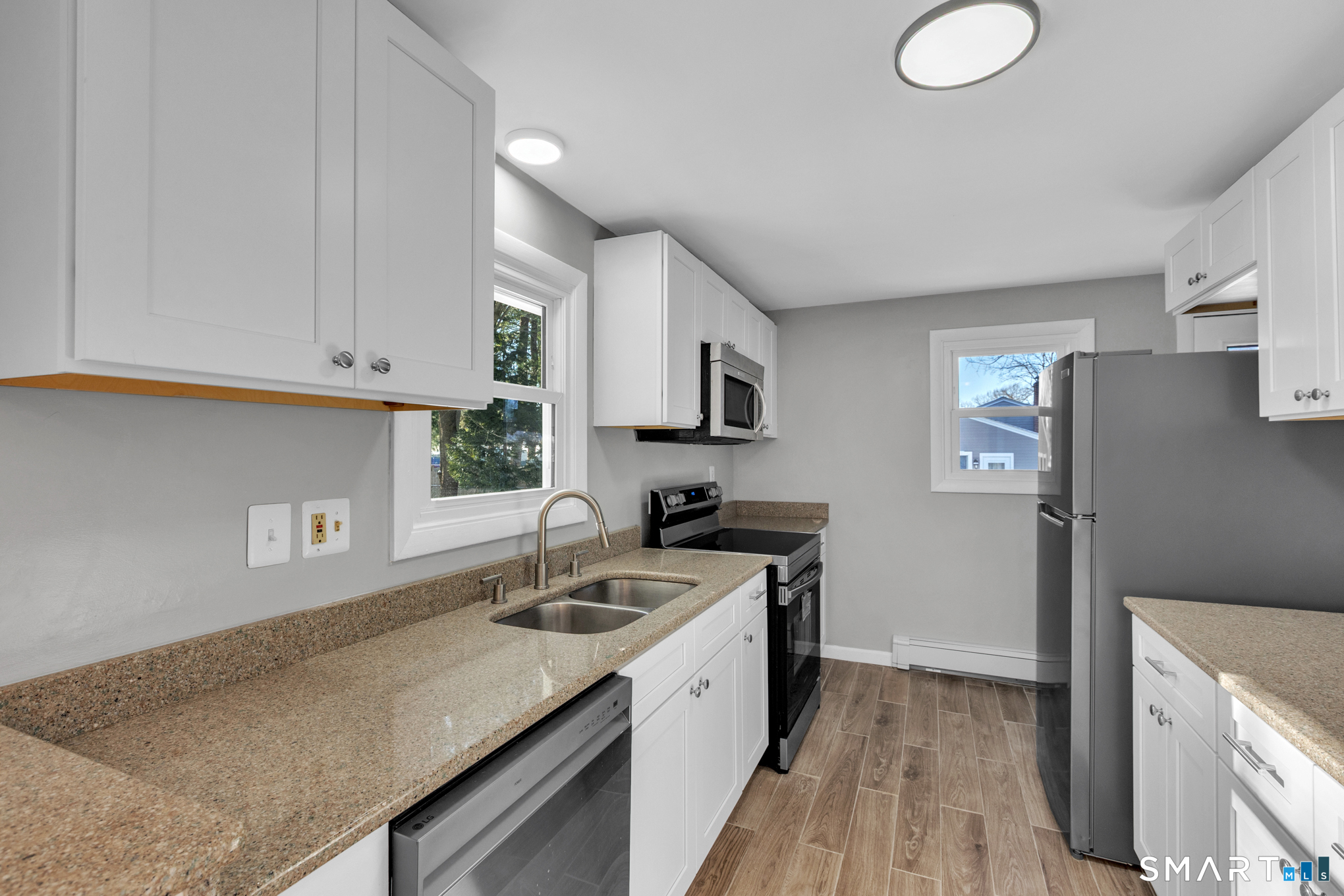 9 Carney Road Enfield, CT 06082 - Photo 6 of 40 a kitchen with a sink stove and microwave