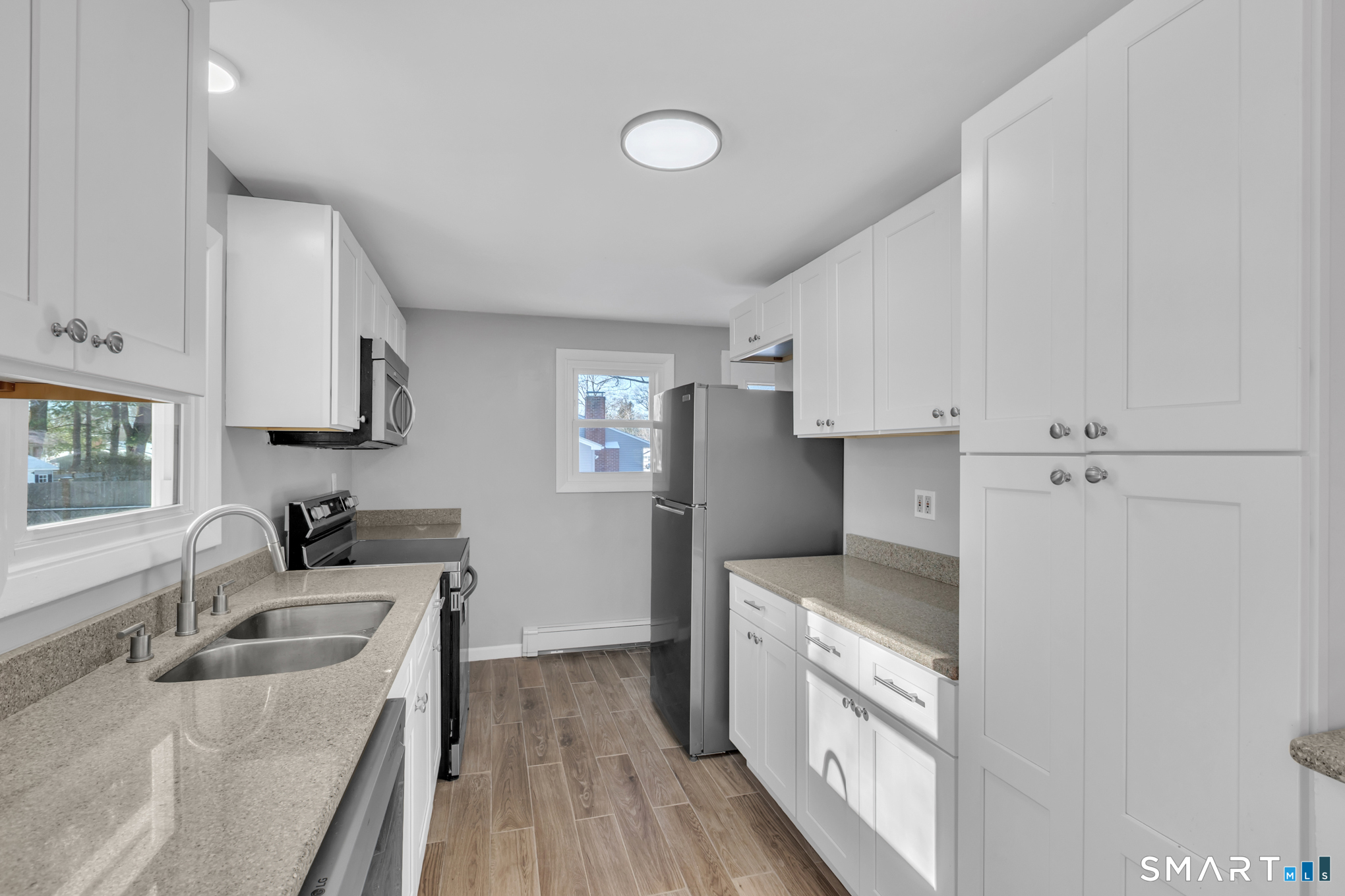 9 Carney Road Enfield, CT 06082 - Photo 7 of 40 a kitchen with granite countertop a sink stove and refrigerator