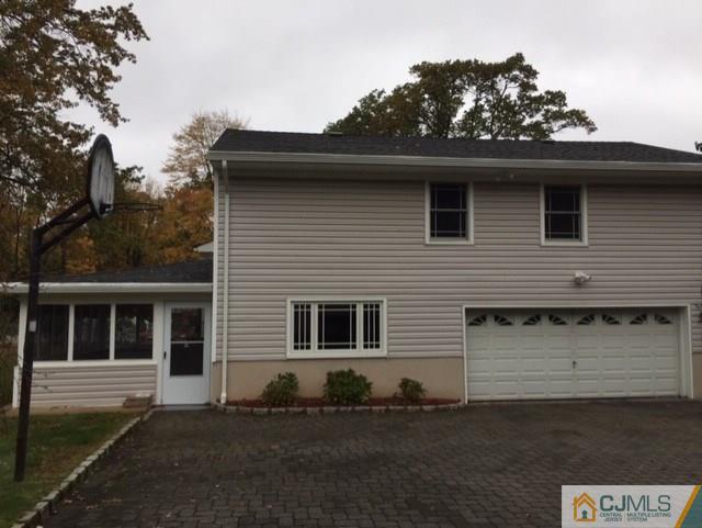 24 Clive Hills Road Edison, NJ 08820 - Photo 2 of 6 a front view of a house with a garden