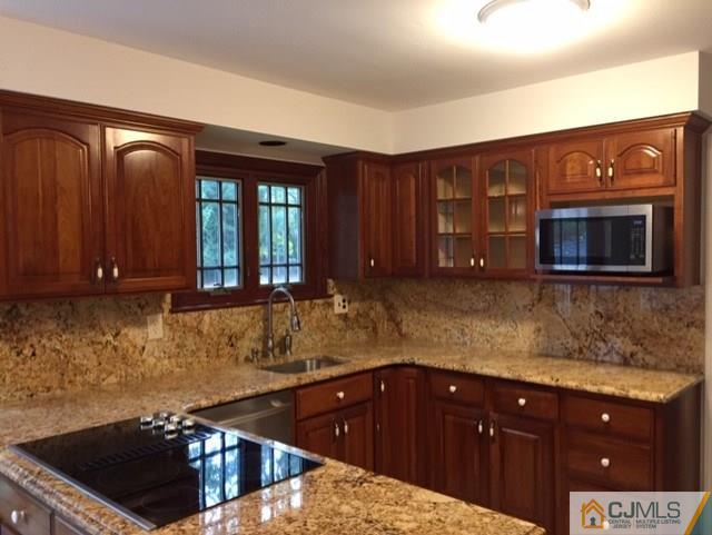 24 Clive Hills Road Edison, NJ 08820 - Photo 3 of 6 a kitchen with stainless steel appliances granite countertop a stove a sink and a microwave