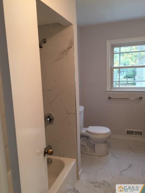 24 Clive Hills Road Edison, NJ 08820 - Photo 5 of 6 a bathroom with a sink a toilet and shower