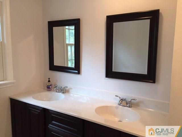 24 Clive Hills Road Edison, NJ 08820 - Photo 6 of 6 a bathroom with 2 sink and a mirror