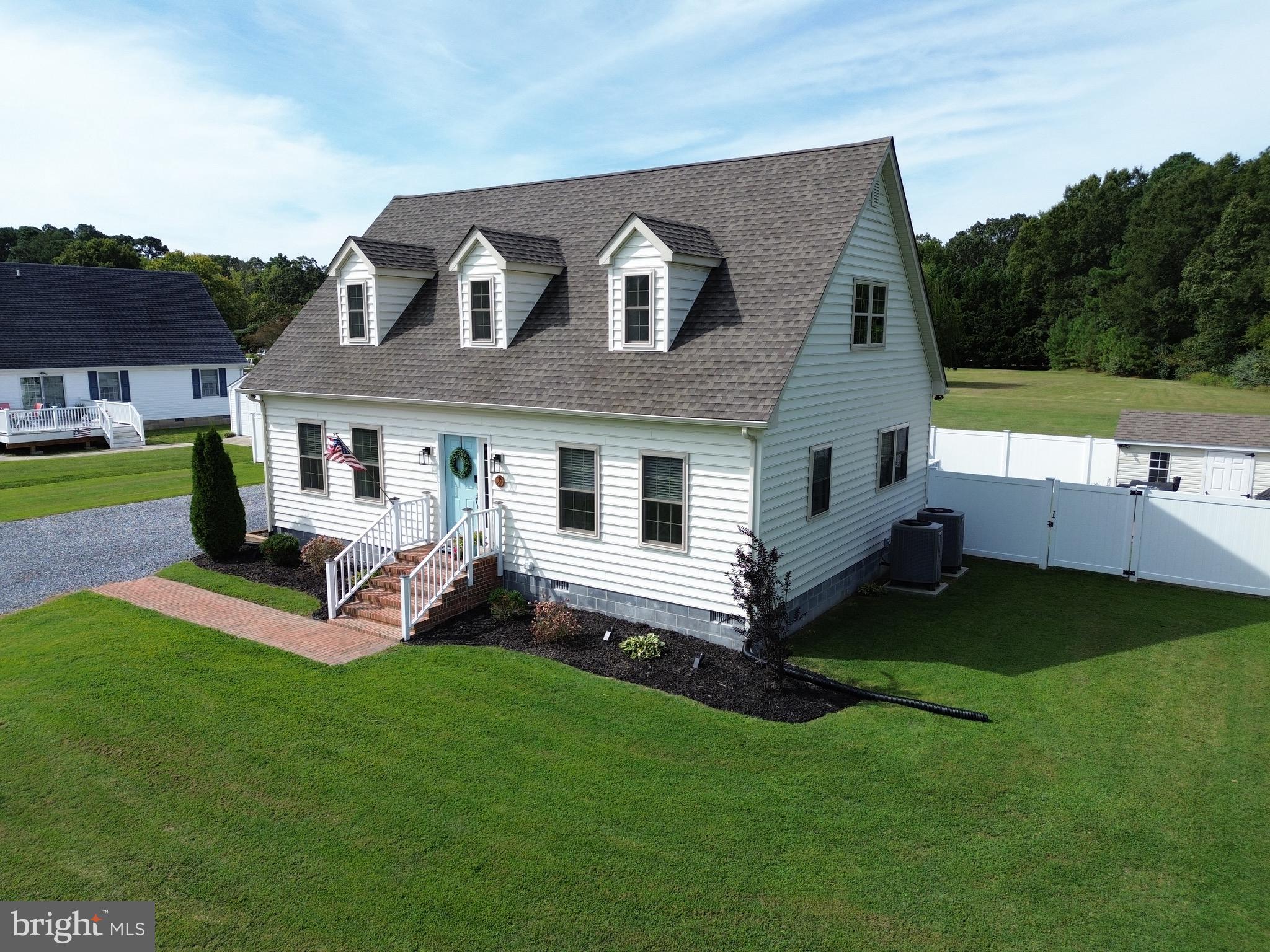 a front view of house with yard and outdoor seating