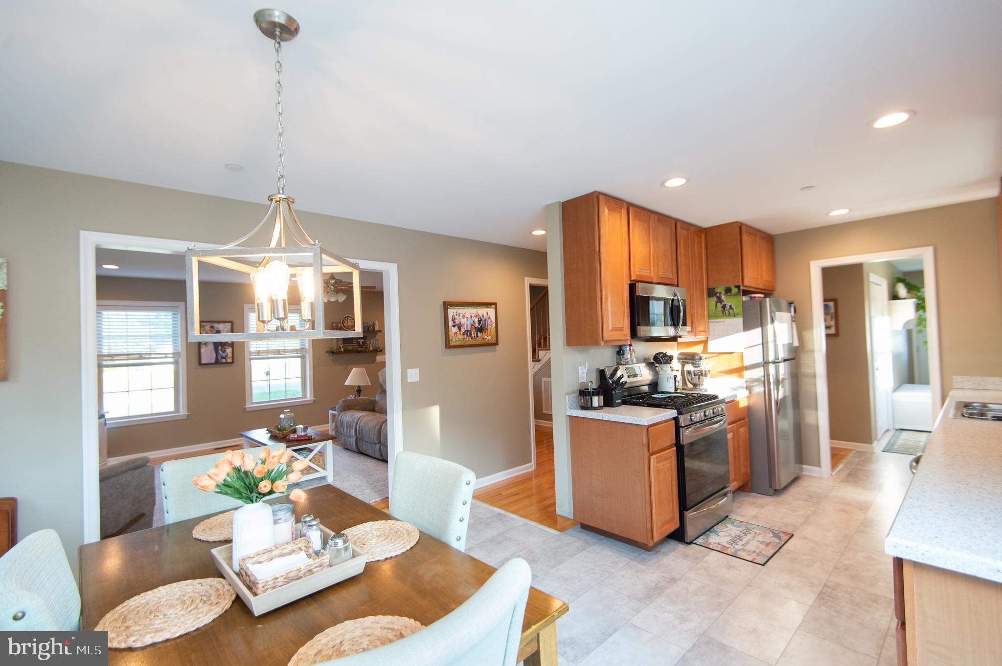 2 Arbutus Terrace Cambridge, MD 21613 - Photo 13 of 41 a kitchen with stainless steel appliances kitchen island granite countertop a refrigerator and stove