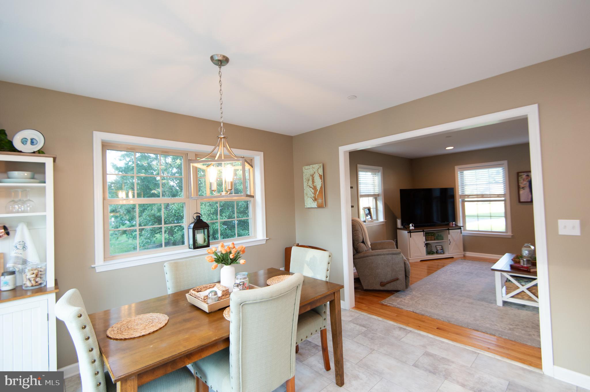2 Arbutus Terrace Cambridge, MD 21613 - Photo 14 of 41 a dining room with furniture a chandelier and wooden floor