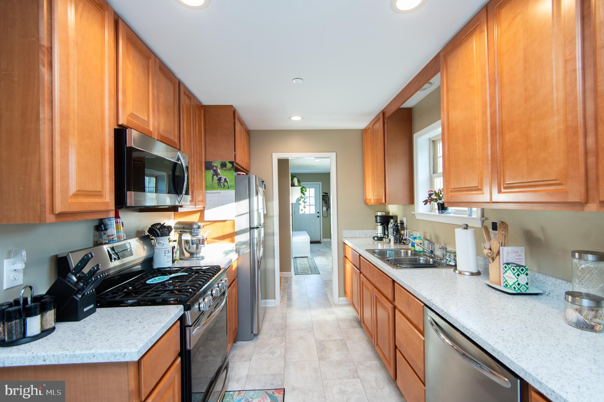 2 Arbutus Terrace Cambridge, MD 21613 - Photo 15 of 41 a kitchen with kitchen island granite countertop a sink a counter top space and stainless steel appliances