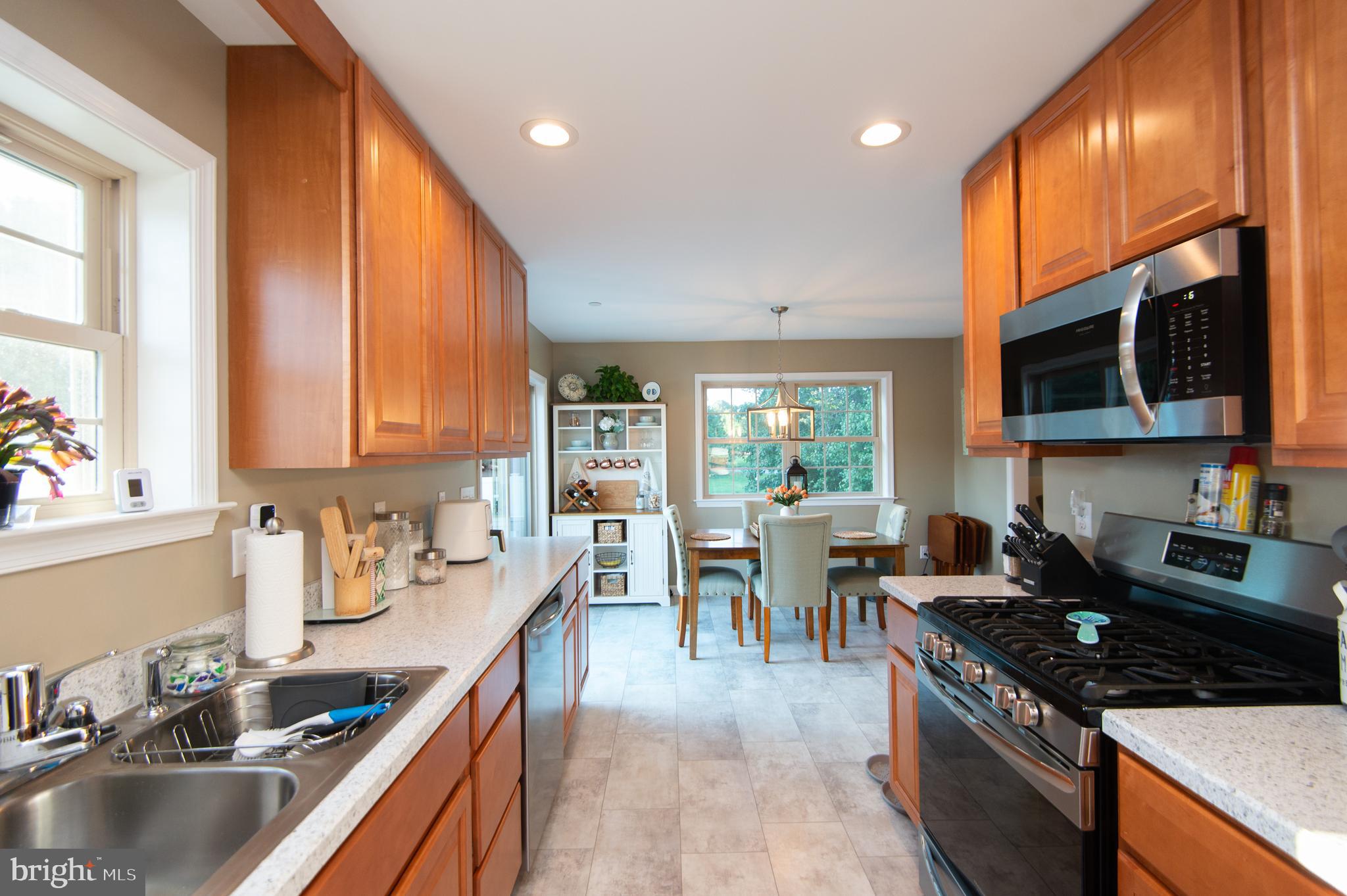 2 Arbutus Terrace Cambridge, MD 21613 - Photo 16 of 41 a kitchen with stainless steel appliances granite countertop sink stove top oven and cabinets