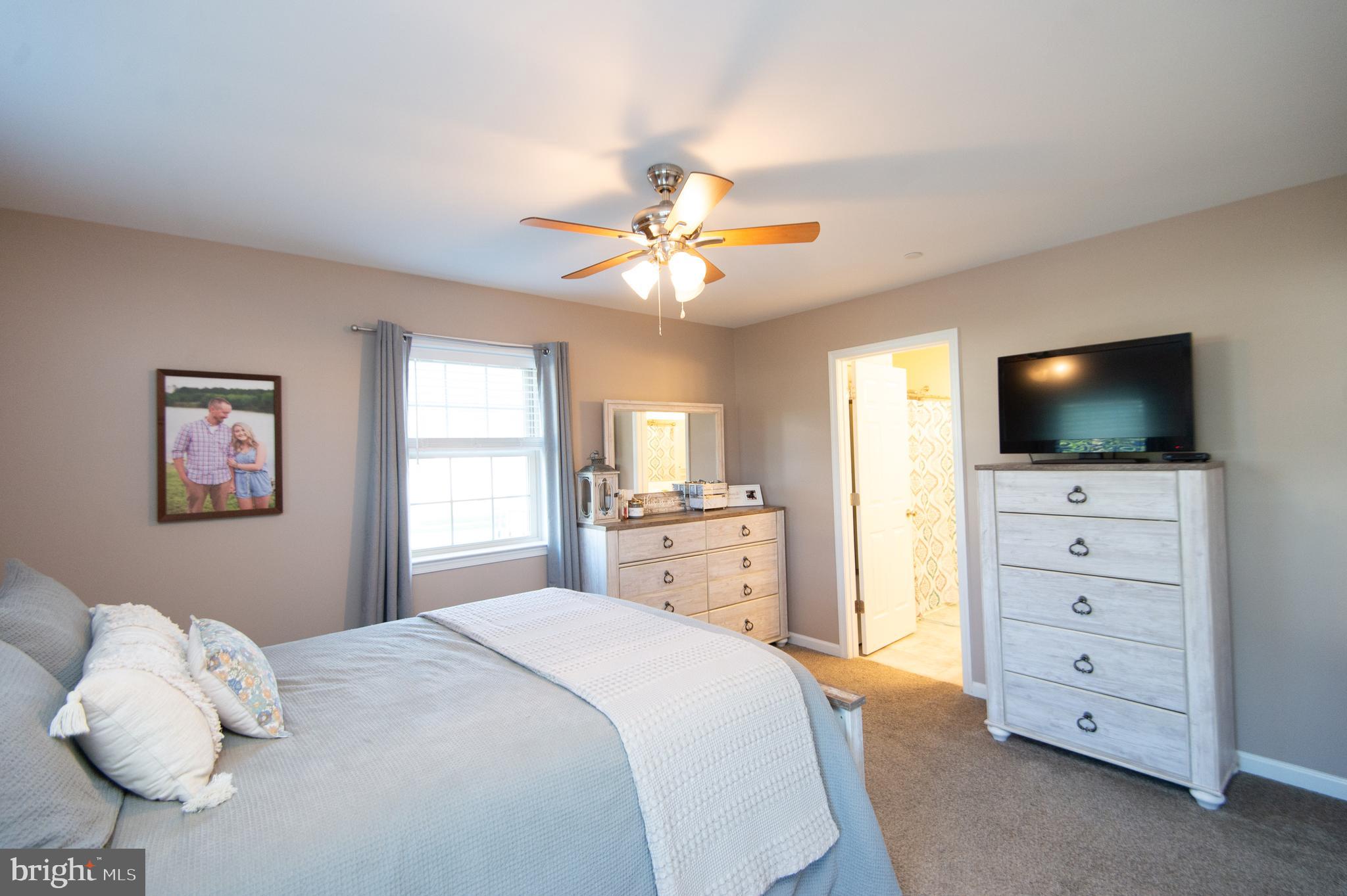 2 Arbutus Terrace Cambridge, MD 21613 - Photo 21 of 41 a bedroom with a bed and a flat screen tv