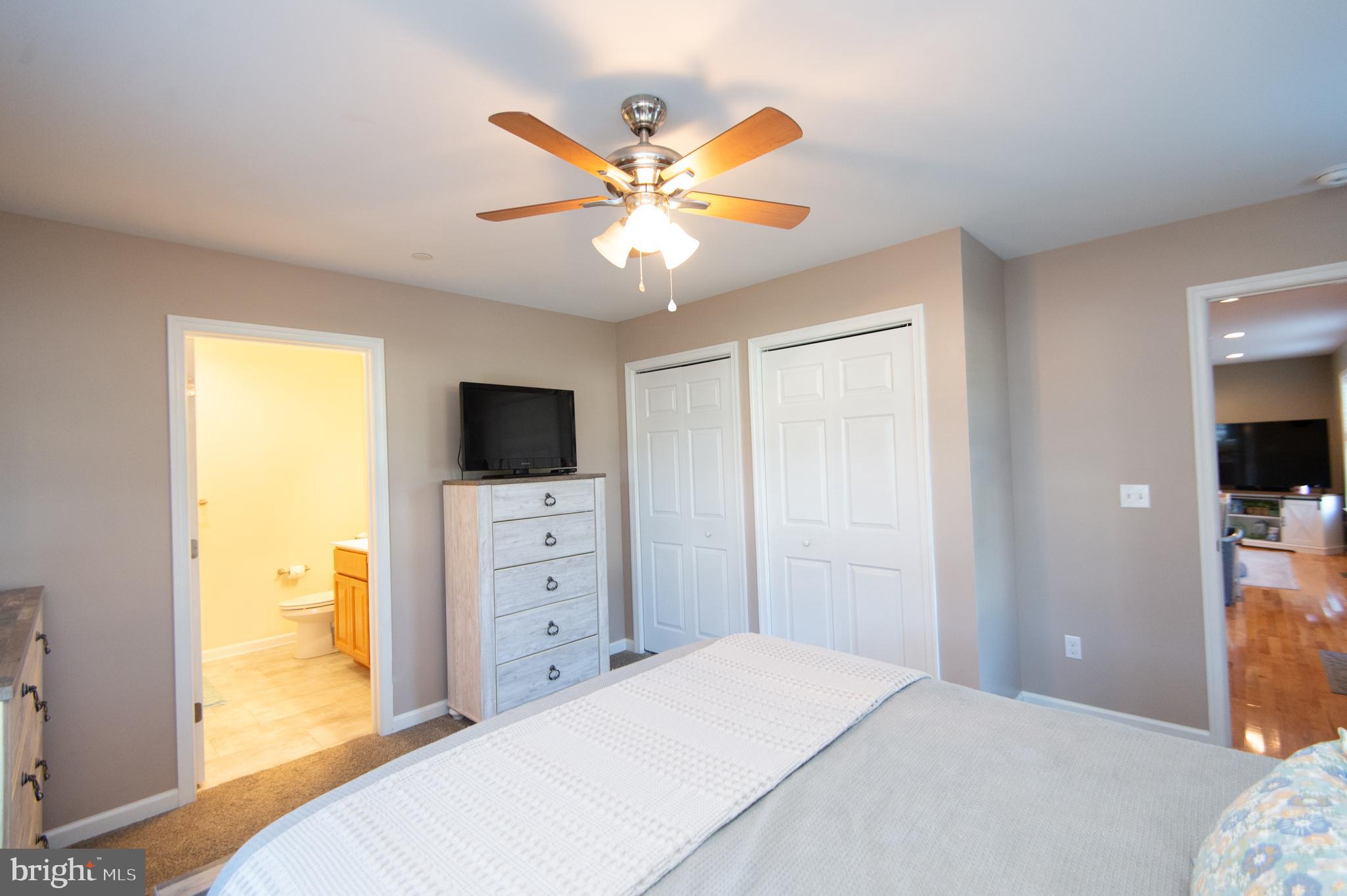 2 Arbutus Terrace Cambridge, MD 21613 - Photo 24 of 41 a bedroom with a bed and a flat screen tv