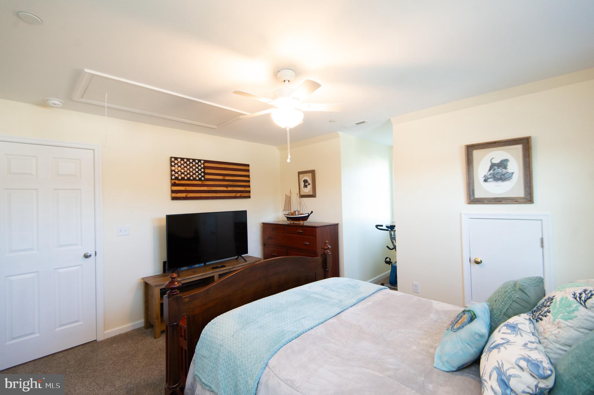 2 Arbutus Terrace Cambridge, MD 21613 - Photo 27 of 41 a bedroom with a bed and a flat screen tv