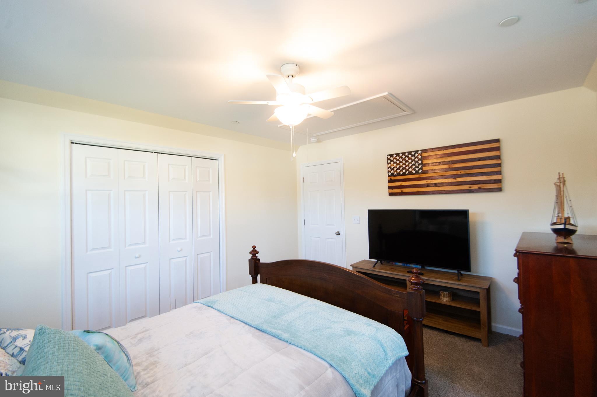 2 Arbutus Terrace Cambridge, MD 21613 - Photo 28 of 41 a bedroom with a bed and a flat screen tv