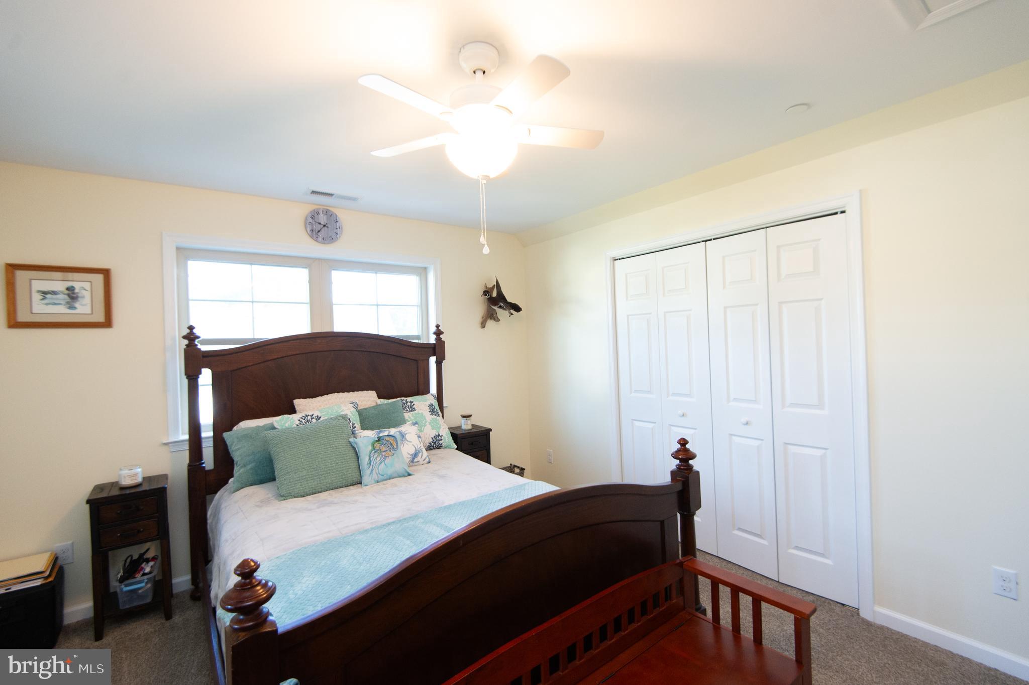 2 Arbutus Terrace Cambridge, MD 21613 - Photo 29 of 41 a bedroom with a bed and a chandelier
