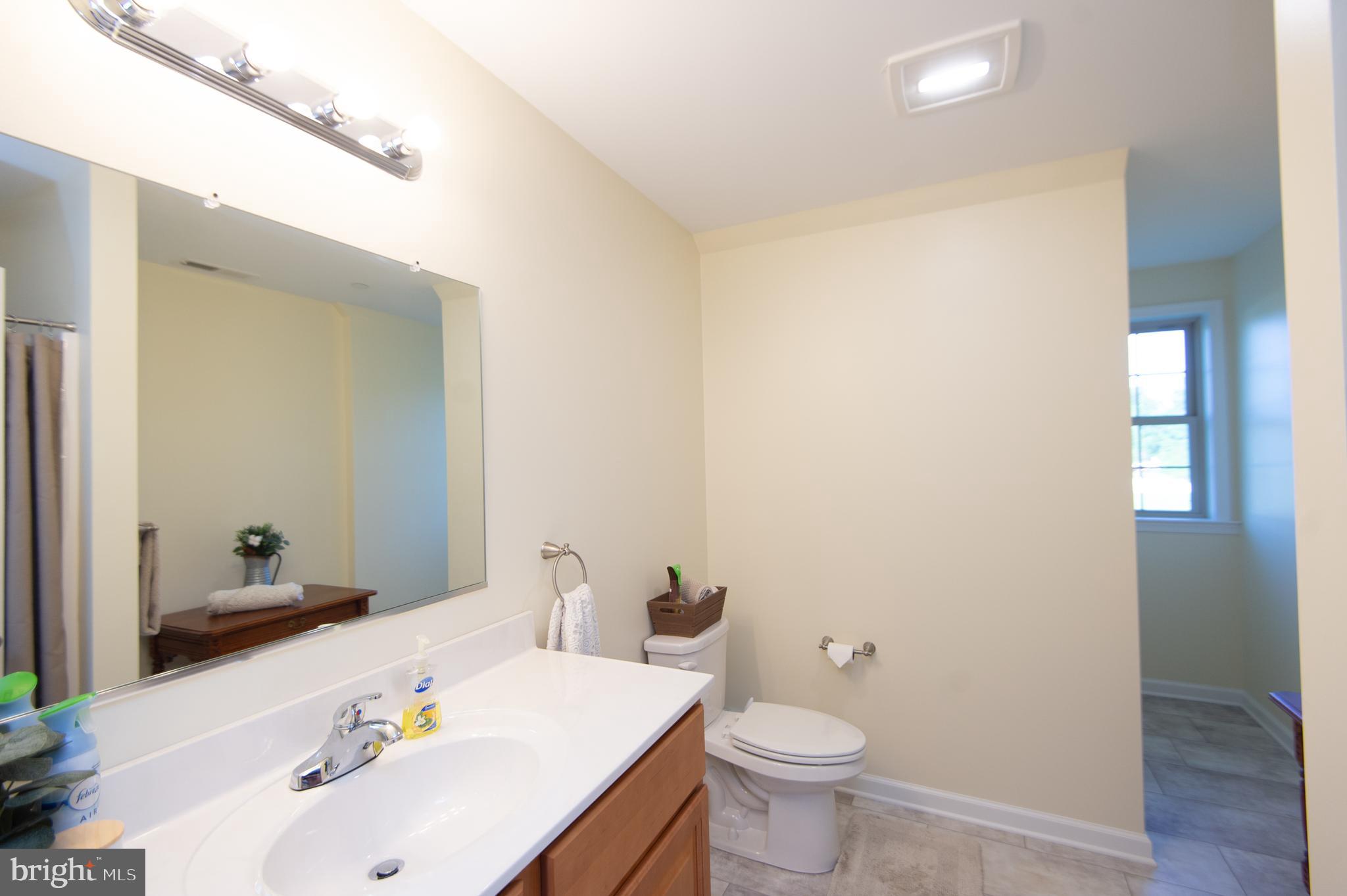 2 Arbutus Terrace Cambridge, MD 21613 - Photo 30 of 41 a bathroom with a sink and a large mirror