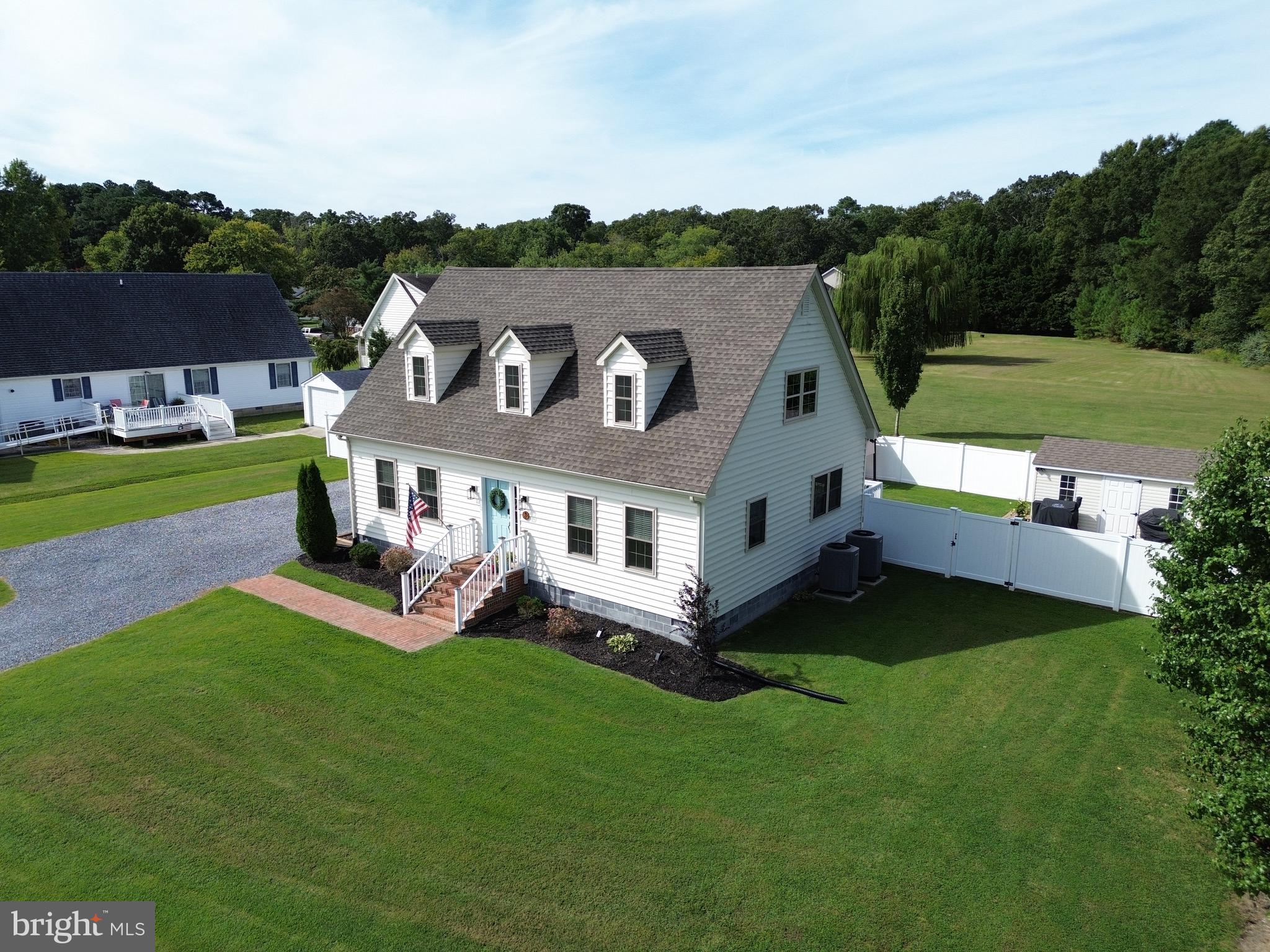 2 Arbutus Terrace Cambridge, MD 21613 - Photo 3 of 41 a aerial view of a house with a yard table and chairs