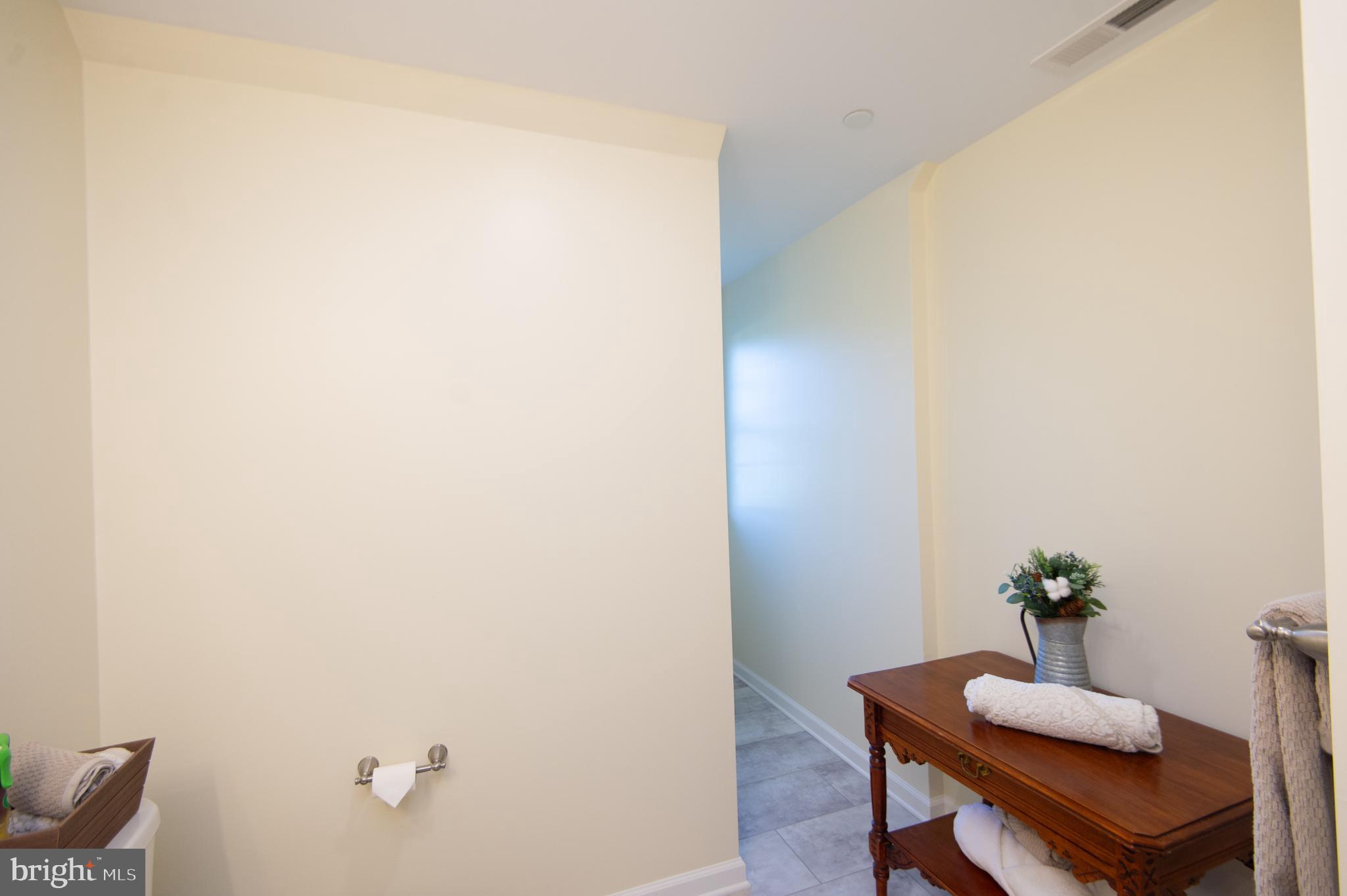 2 Arbutus Terrace Cambridge, MD 21613 - Photo 31 of 41 a room with a table and a potted plant