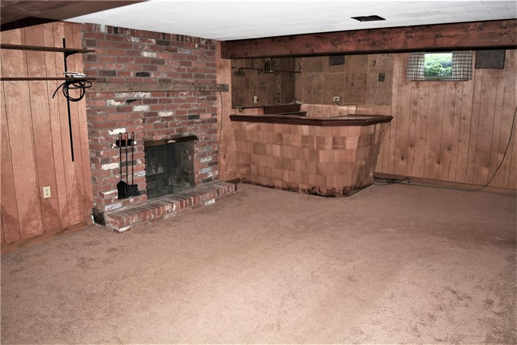 313 Woodcroft Road Economy, PA 15005 - Photo 17 of 23 finished gameroom with wood burning fireplace and bar