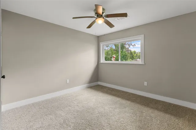 a view of room with window and ceiling fan