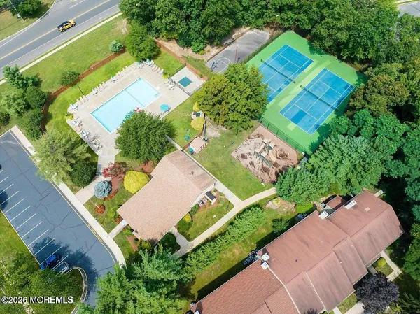 an aerial view of a house with a garden and swimming pool