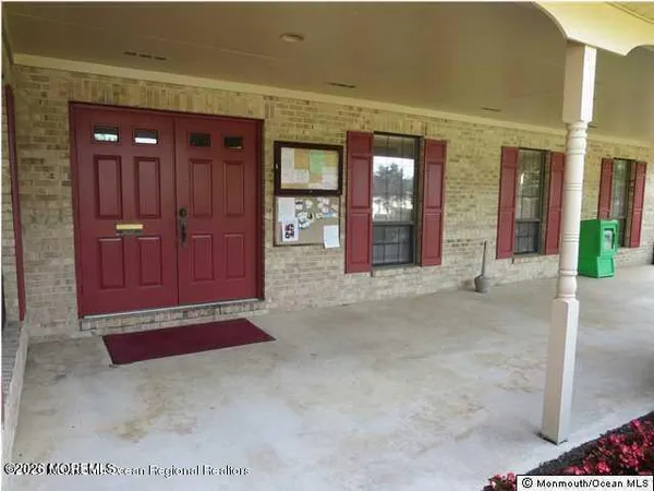 a view of a hallway with wooden floor and windows