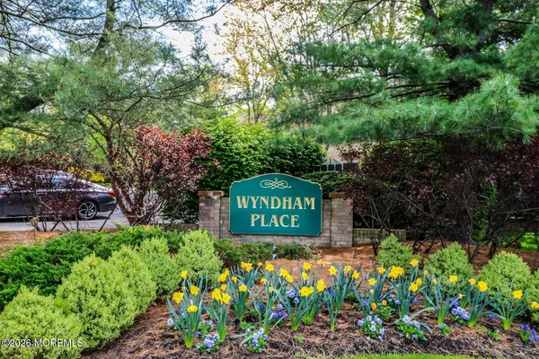 a sign that is sitting in front of flowers