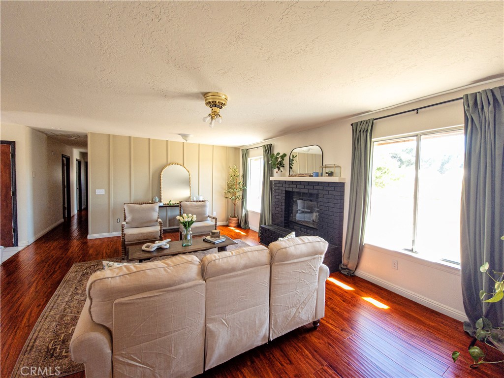 9995 Smoke Tree Road Hesperia, CA 92344 - Photo 13 of 74 a living room with furniture fireplace and wooden floor