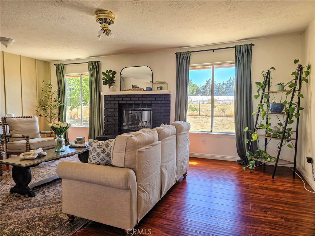 9995 Smoke Tree Road Hesperia, CA 92344 - Photo 14 of 74 a living room with furniture floor to ceiling window and wooden floor
