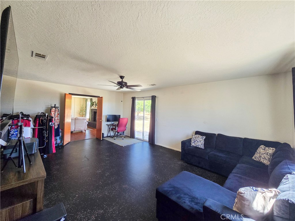 9995 Smoke Tree Road Hesperia, CA 92344 - Photo 17 of 74 a living room with furniture and wooden floor