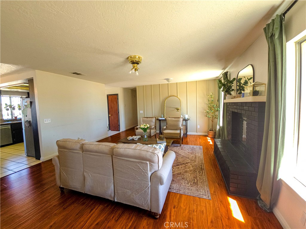 9995 Smoke Tree Road Hesperia, CA 92344 - Photo 18 of 74 a living room with furniture and a fireplace