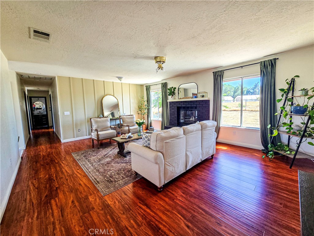 9995 Smoke Tree Road Hesperia, CA 92344 - Photo 28 of 74 a living room with furniture and a wooden floor