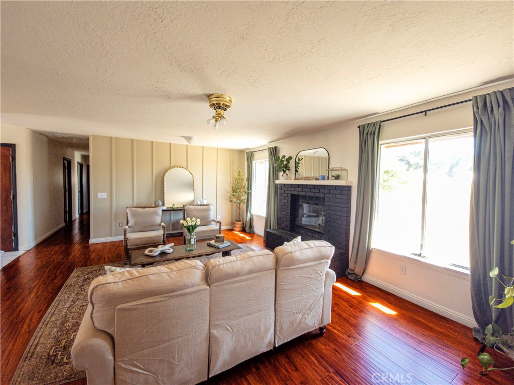 9995 Smoke Tree Road Hesperia, CA 92344 - Photo 40 of 74 a living room with furniture fireplace and wooden floor