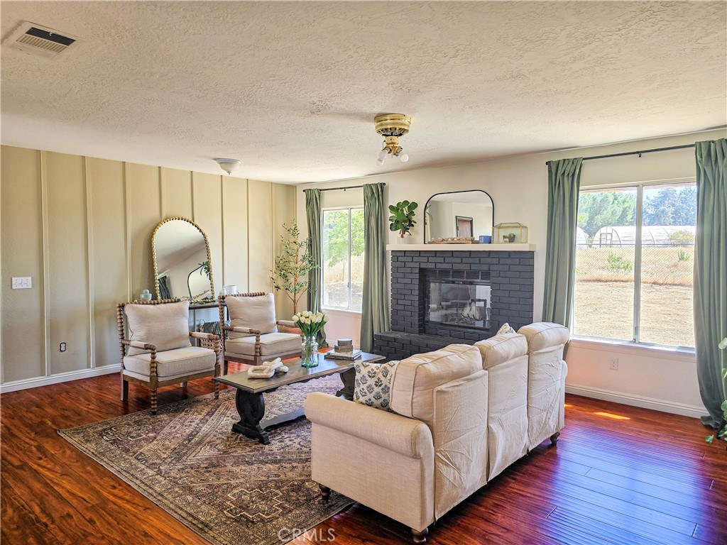 9995 Smoke Tree Road Hesperia, CA 92344 - Photo 4 of 74 a living room with furniture fireplace and a large window