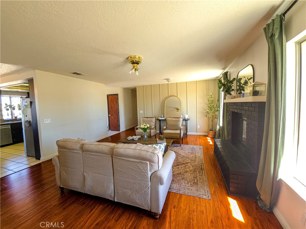 9995 Smoke Tree Road Hesperia, CA 92344 - Photo 59 of 74 a living room with furniture and a fireplace