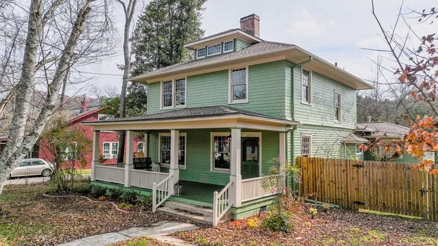 a view of house with a yard
