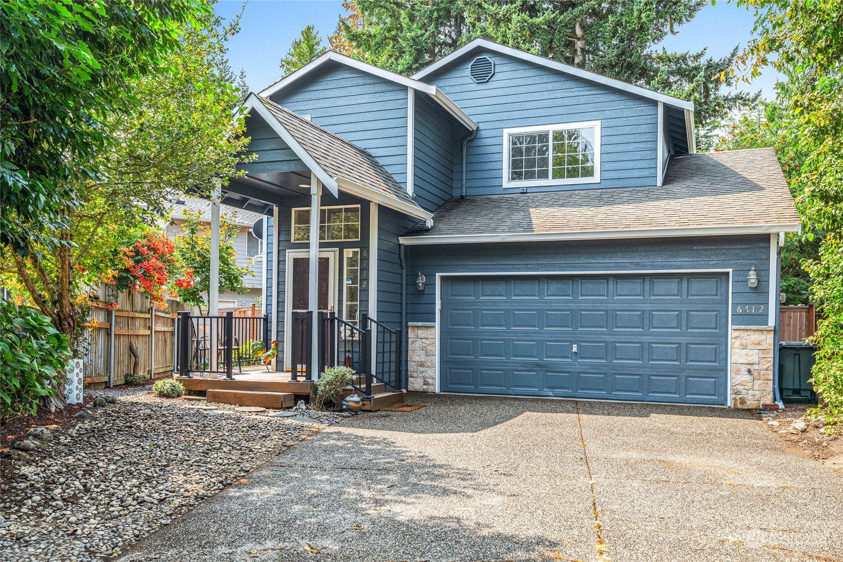 6712 Lower Ridge Road Everett, WA 98203 - Photo 1 of 34 a front view of a house with a yard and garage