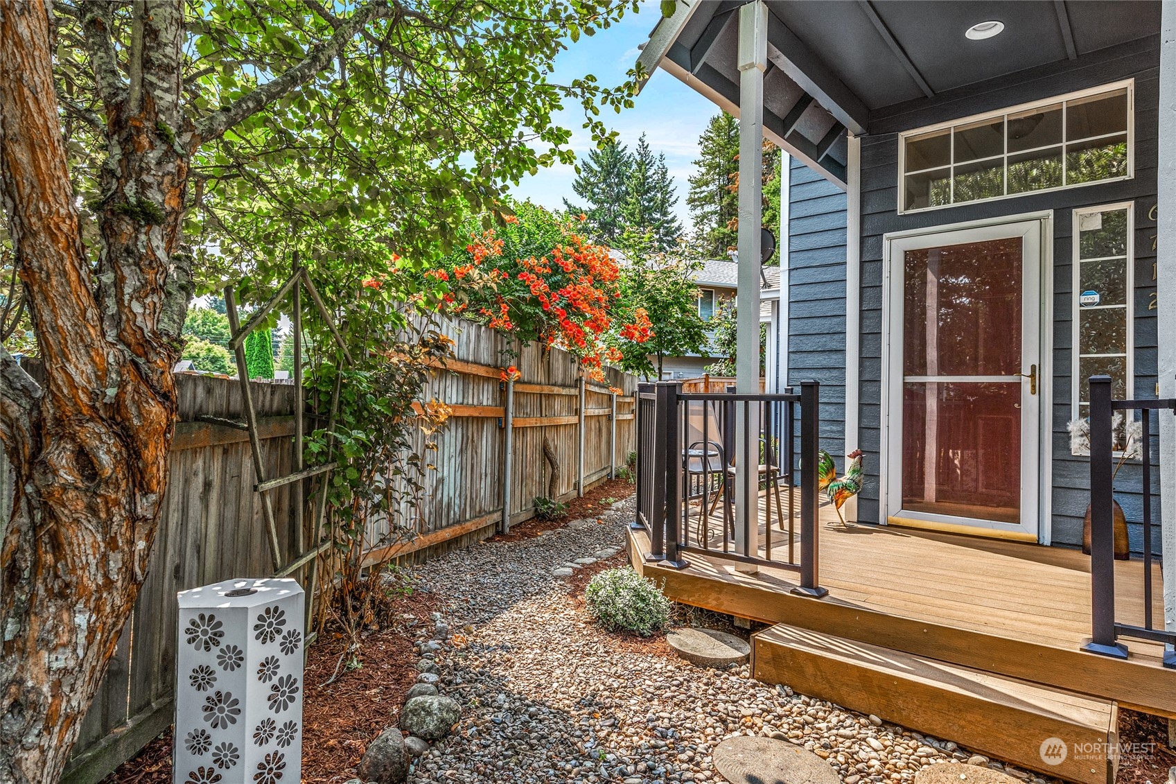 6712 Lower Ridge Road Everett, WA 98203 - Photo 2 of 34 a view of a house with a small yard and wooden fence and large trees
