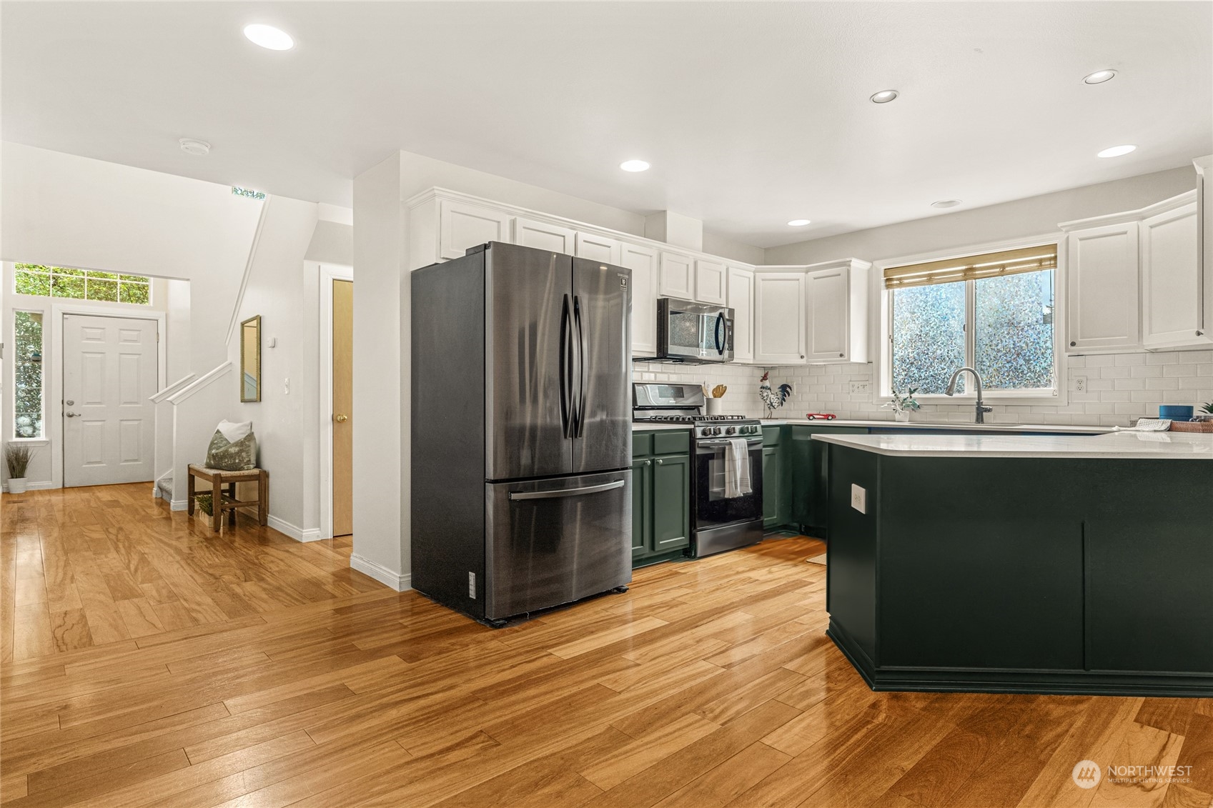 6712 Lower Ridge Road Everett, WA 98203 - Photo 7 of 34 a kitchen with stainless steel appliances granite countertop a refrigerator a sink a stove with wooden cabinets