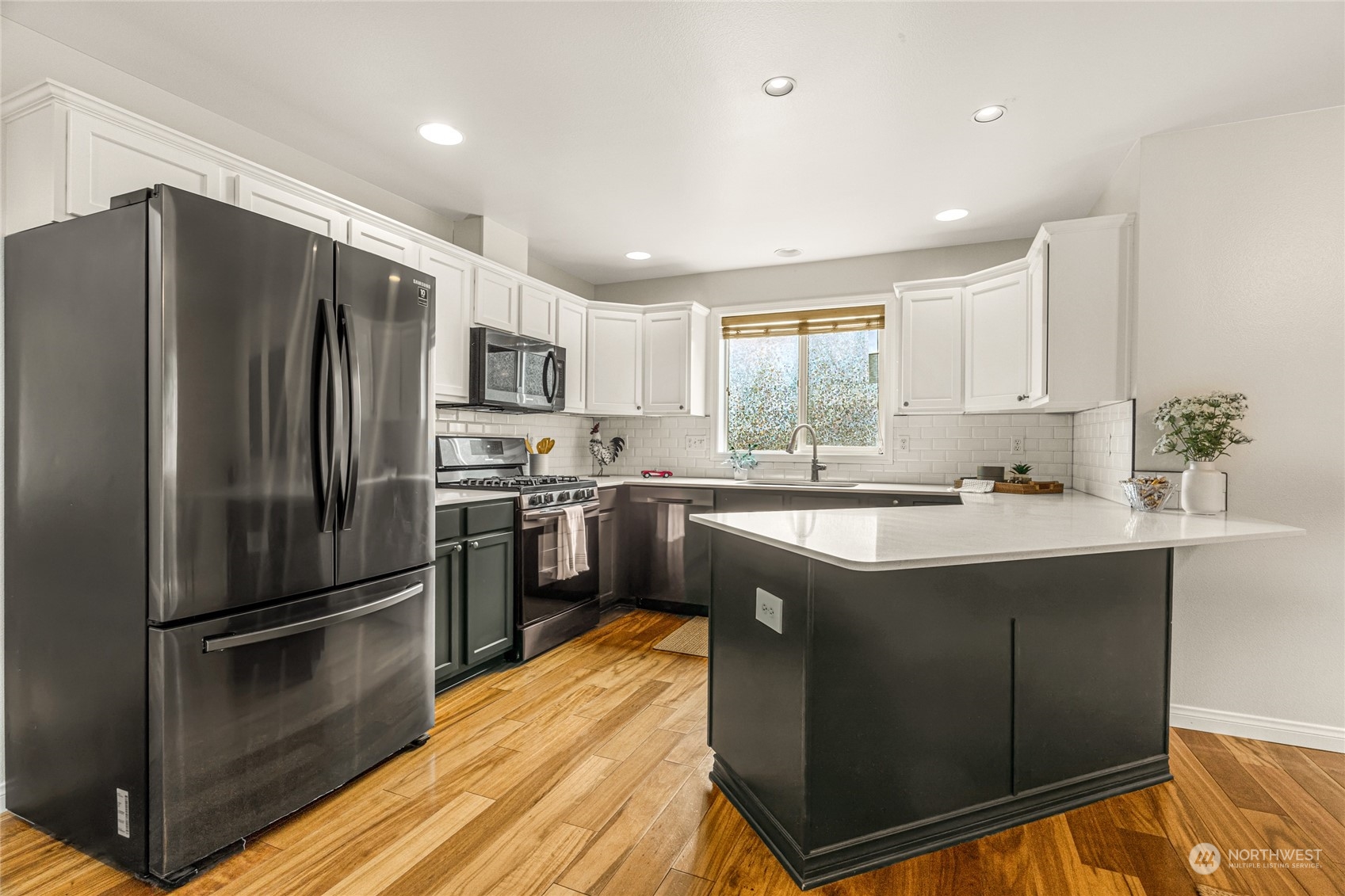 6712 Lower Ridge Road Everett, WA 98203 - Photo 9 of 34 a kitchen with kitchen island a counter top space stainless steel appliances and windows
