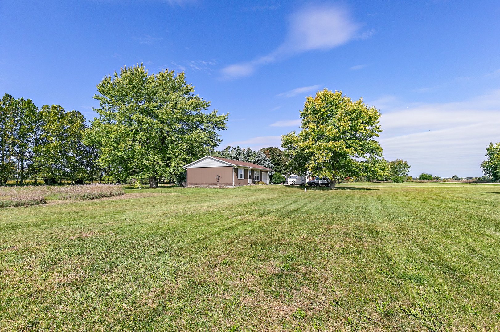 5815 Johnson Road Marengo, IL 60152 - Photo 23 of 30 a yellow house with garden in front of it