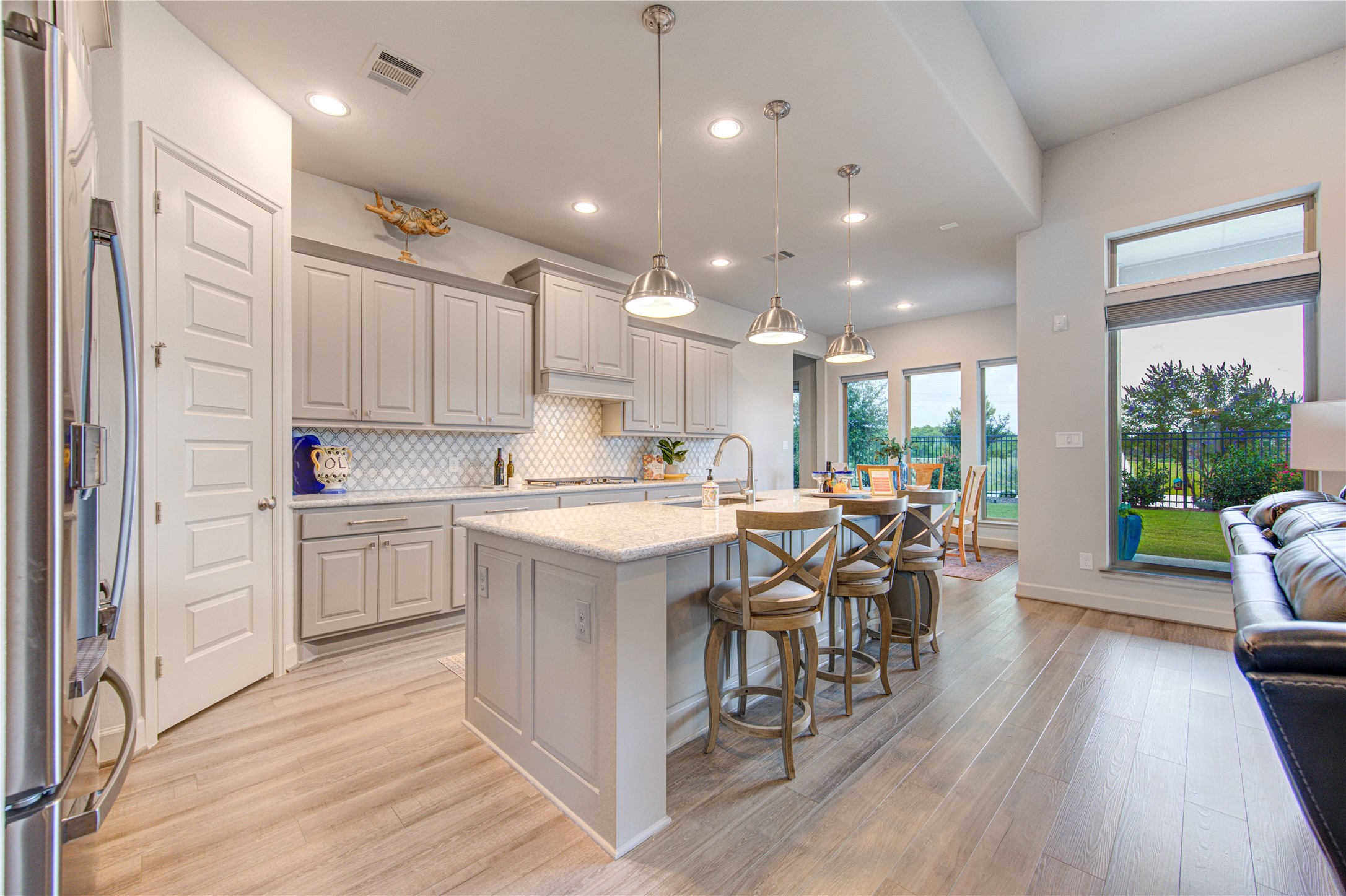 7326 Orangetip Road Katy, TX 77493 - Photo 1 of 43 Gourmet Kitchen with a View: Designed for both beauty and functionality, the kitchen features sleek Quartz countertops, custom cabinetry, a large island with bar seating, and stainless steel appliances. Enjoy lake views as you cook and entertain.