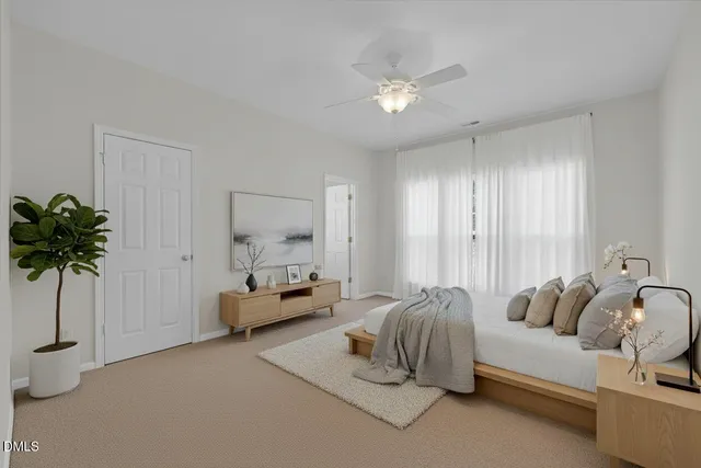 a spacious bedroom with a bed and a chandelier