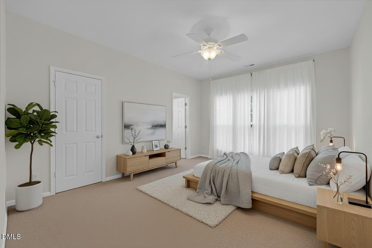 12014 Fox Valley Street Raleigh, NC 27614 - Photo 14 of 42 a spacious bedroom with a bed and a chandelier