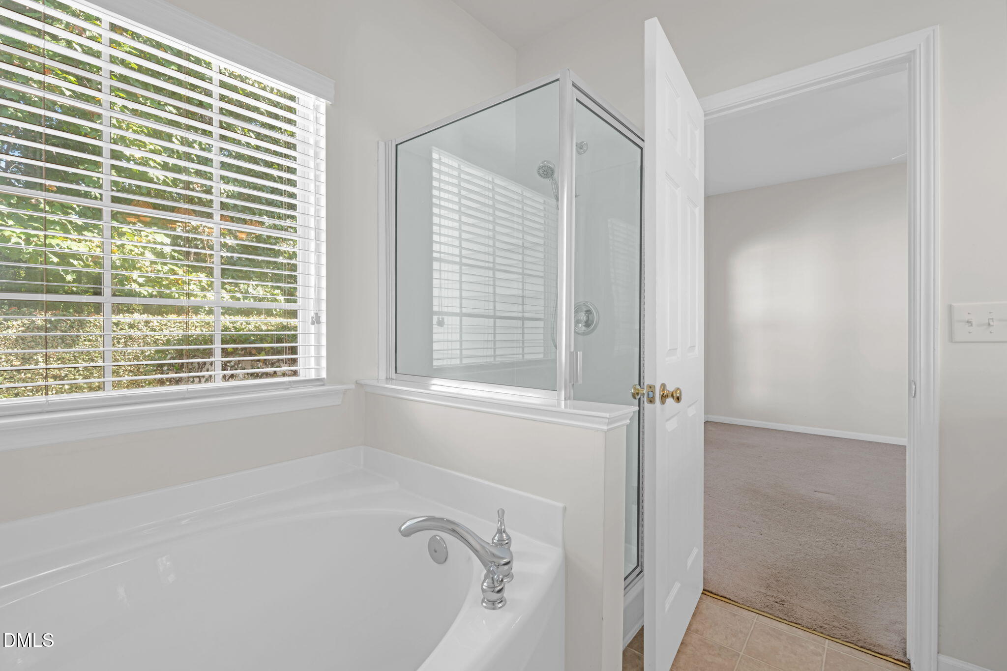 12014 Fox Valley Street Raleigh, NC 27614 - Photo 17 of 42 a bathroom with a bathtub and next to a window