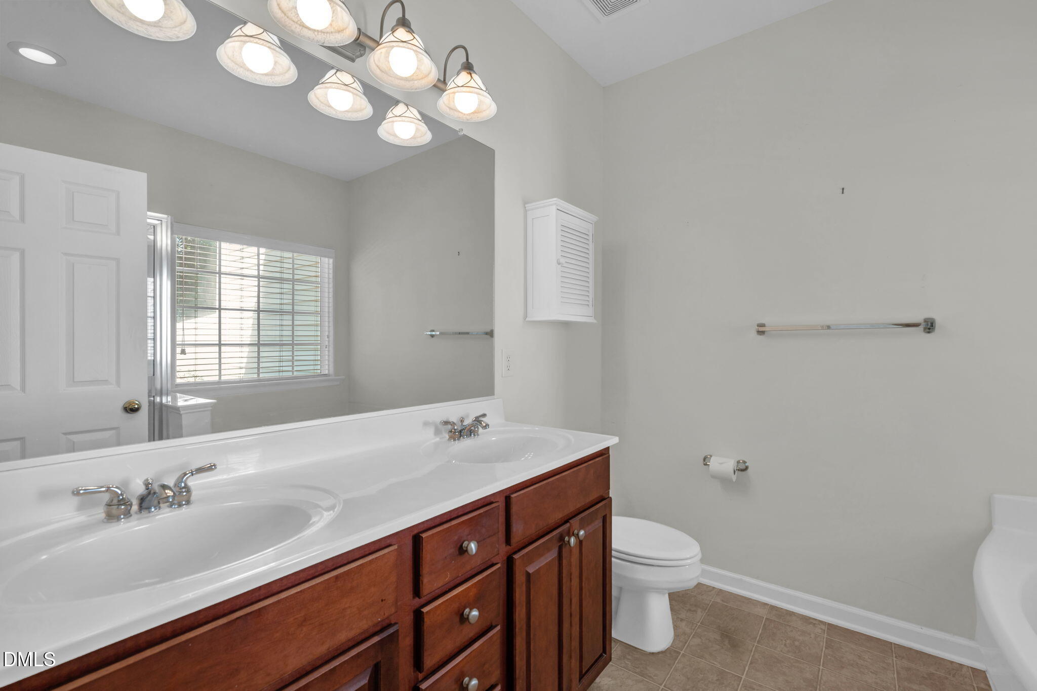 12014 Fox Valley Street Raleigh, NC 27614 - Photo 18 of 42 a bathroom with a granite countertop sink a toilet and a mirror